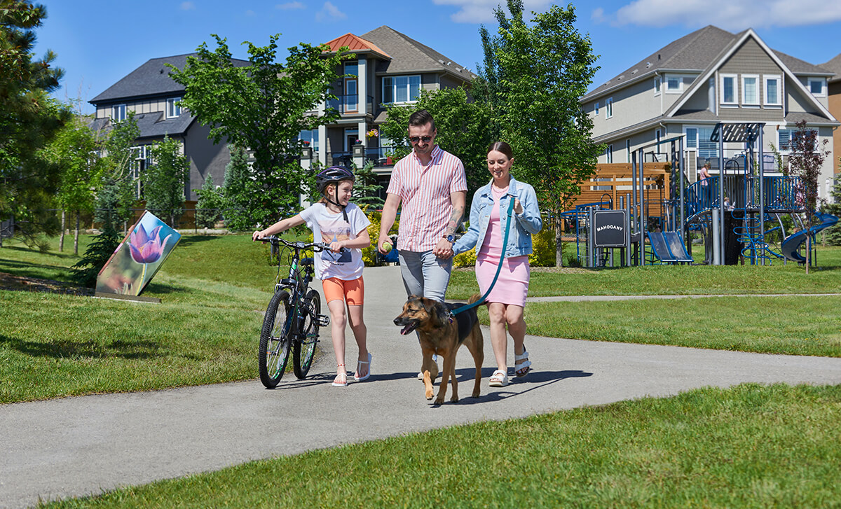 Family walking their dog on pathway